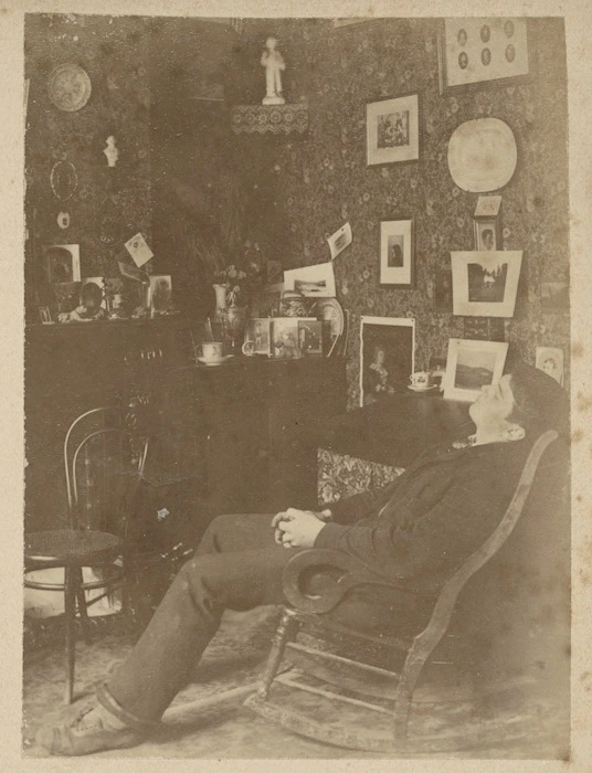 Room interior with young man in a rocking chair