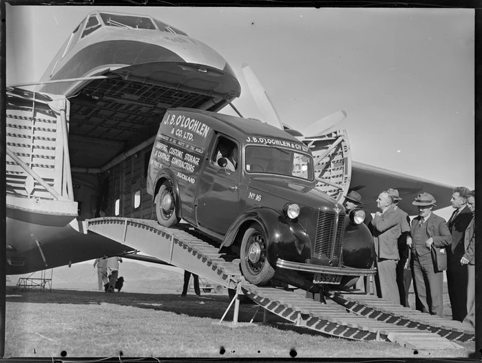 J B O'Loghlen and Company Limited truck containing parcels etc, Kaikohe, departing a Bristol Freighter aircraft, delivering parcels to town