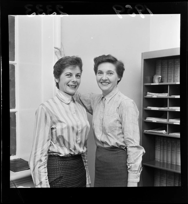 Two unidentified policewomen, who are departing for the United Kingdom, in an office, probably Wellington