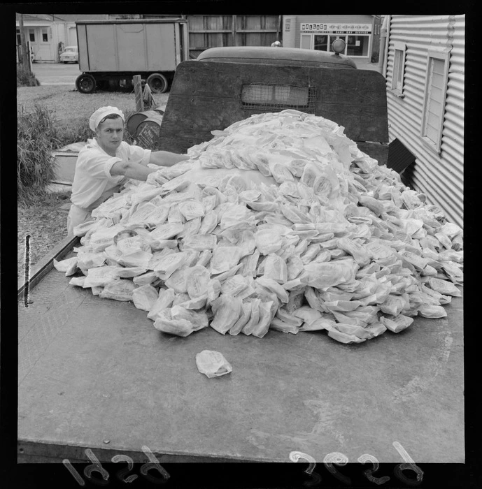 An unidentified baker with a pile of pies from Jax Pies Ltd, left over from opening celebrations at Wellington Airport