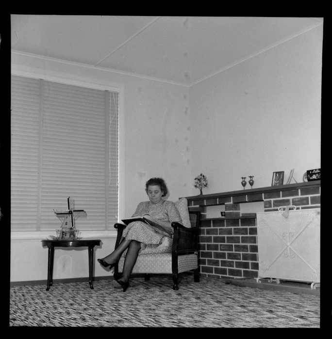Mrs Mabel Howard, in her new house in Karori, Wellington, showing her sitting in a chair