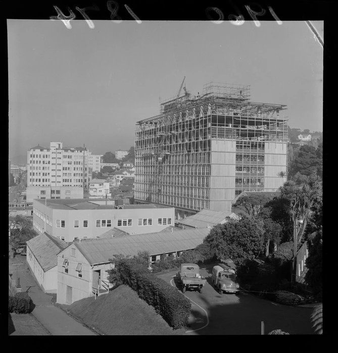 View of the new Government Buildings under construction on Bowen Street behind Parliament Building with Broadcasting House in front, Wellington City