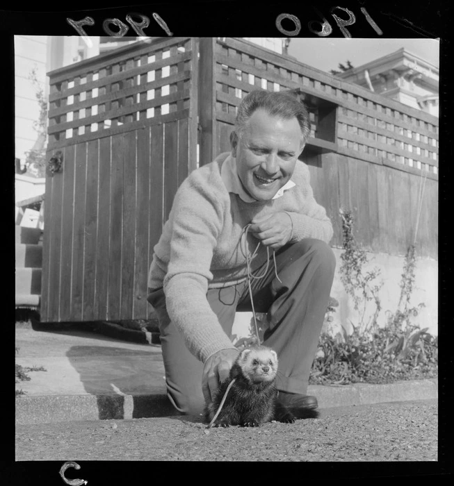 Mr Hartman and his pet ferret at an unknown outdoor location, probably Wellington Region