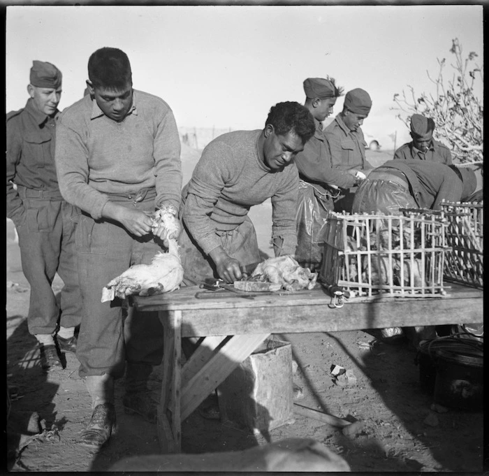 Probably members of the Maori Battalion preparing birds for a Christmas hangi at Baggush, Egypt