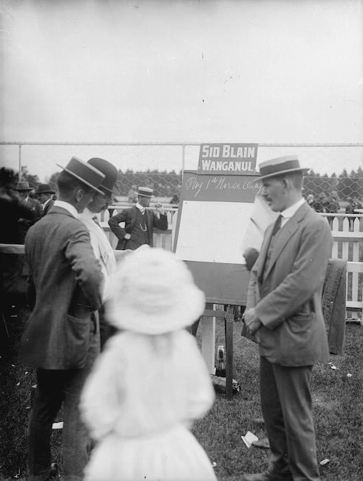 Group by a betting blackboard, Wanganui racecourse