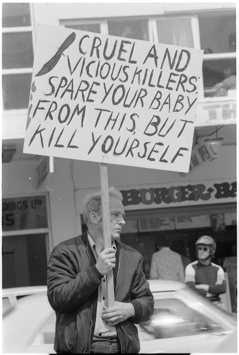 Anti-abortion protestor with placard, 1978 International Women's Day march, Wellington