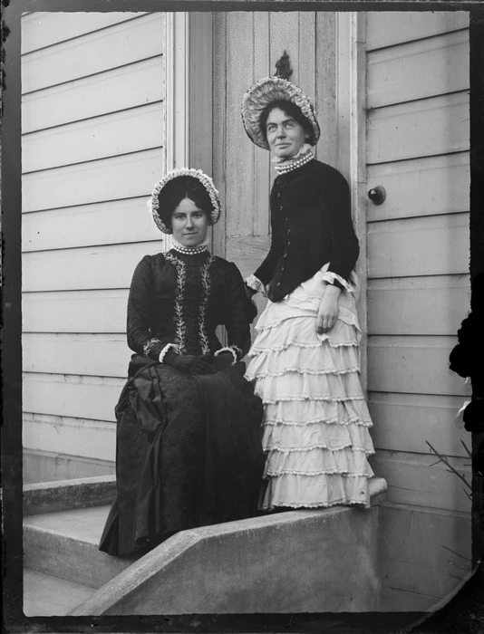 Lydia Devereux and unidentified woman outside a house, unknown location