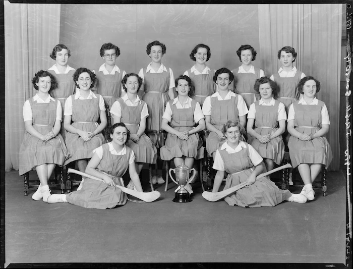Wellington Irish National Society camogie team, with trophy and camogie sticks