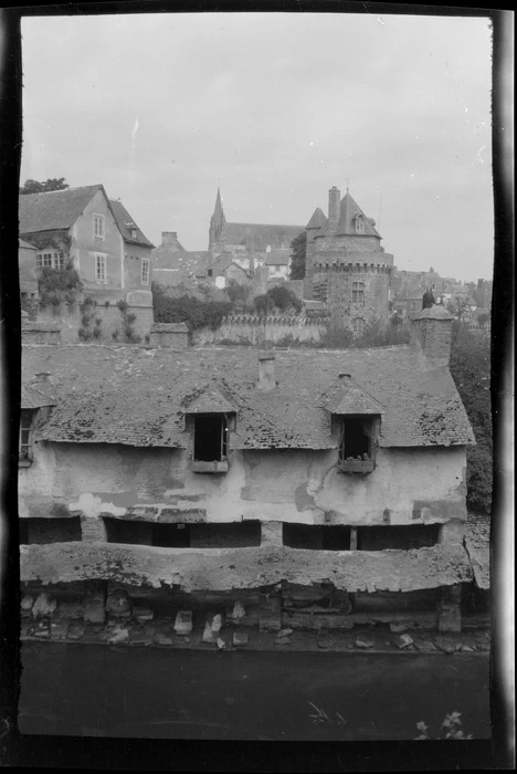 Elevated view of a house with a shingled roof, and river along the ramparts, with buildings beyond, Vannes, Brittany, France