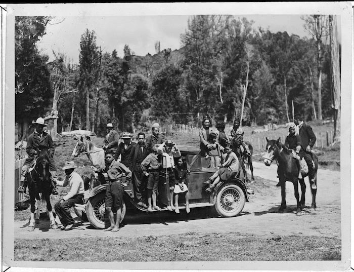 Maori children surround one of the first cars to arrive in Ruatahuna