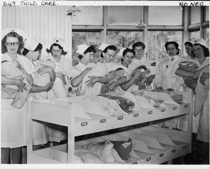 Voluntary Aid Detachment nurses holding infants at the Alexandra Maternity Home in Wellington