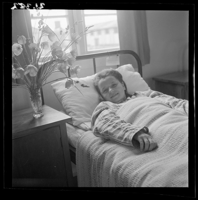 Genia Sajewicz lies in bed in a hospital ward at a Polish refugee camp, Pahiatua