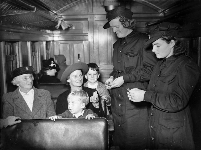 Women tram conductors, taking tickets