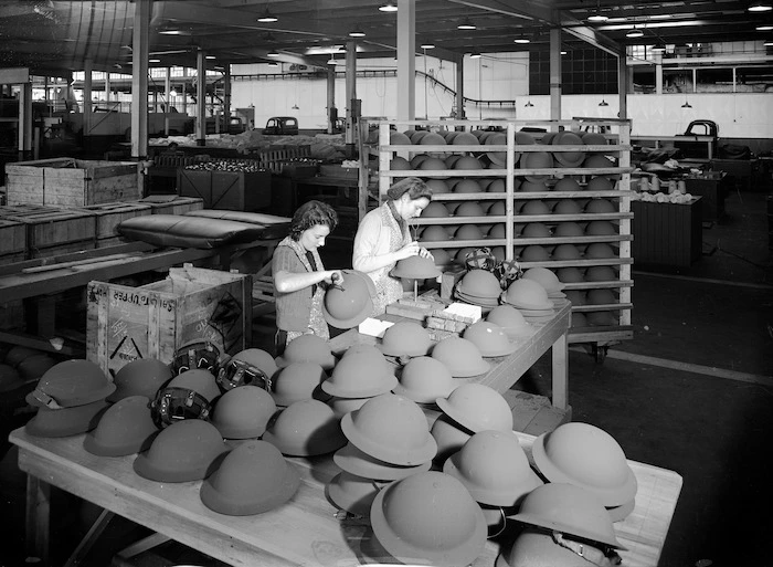 Two unidentified women working on military helmets during World War 2