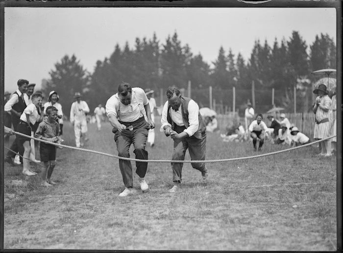 Men competing in an egg and spoon race