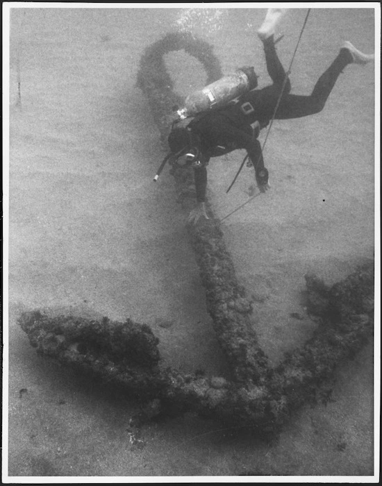 Scuba diver on the sea bed at Doubtless Bay alongside the first of the three anchors of the St Jean Baptiste to be discovered