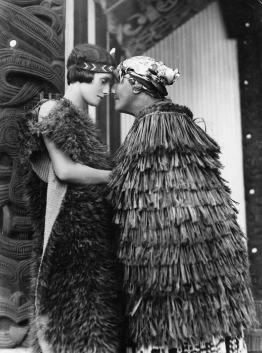 Moore & Thompson, fl 1936-1942 (Firm) : Photograph of Guide Bella, and Jean Batten, greeting each other with a hongi