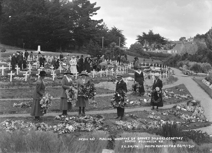 Group placing wreaths on graves in the soldiers section of the Karori Cemetery, Karori, Wellington, on Anzac Day, 1921