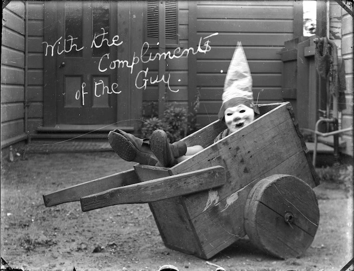 William Godber dressed up for Guy Fawkes celebrations, seated in a wooden wheelbarrow
