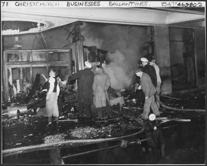 Workers in the burnt wreckage of Ballantyne's department store, trying to make an entrance to the basement