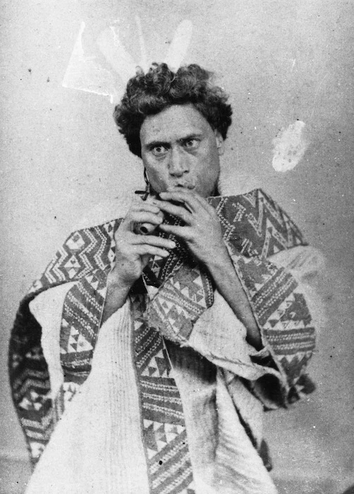 Maori man playing a flute