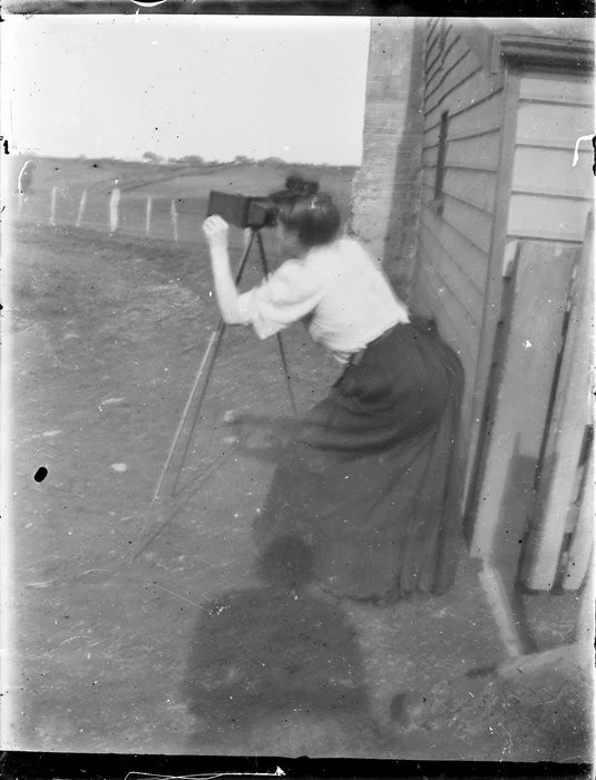 Woman with camera on tripod
