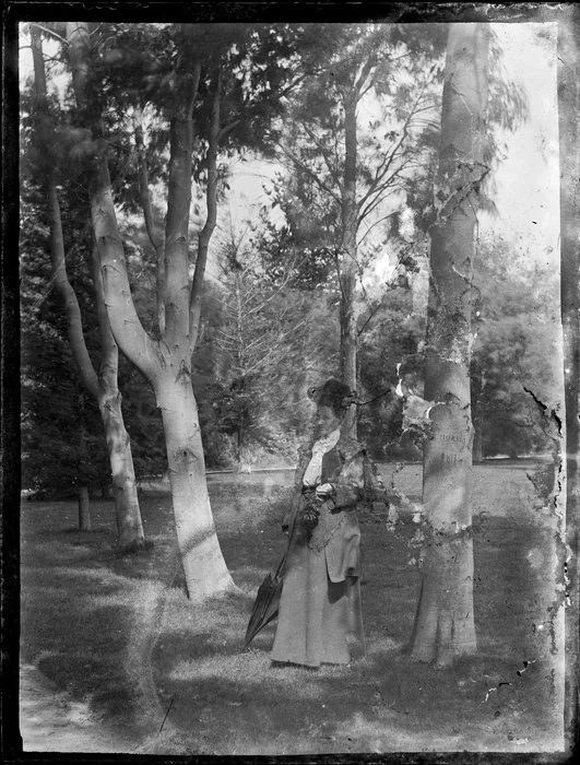 Woman standing among trees
