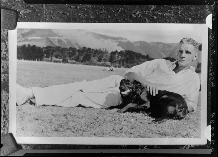 Unidentified man with dog, in countryside