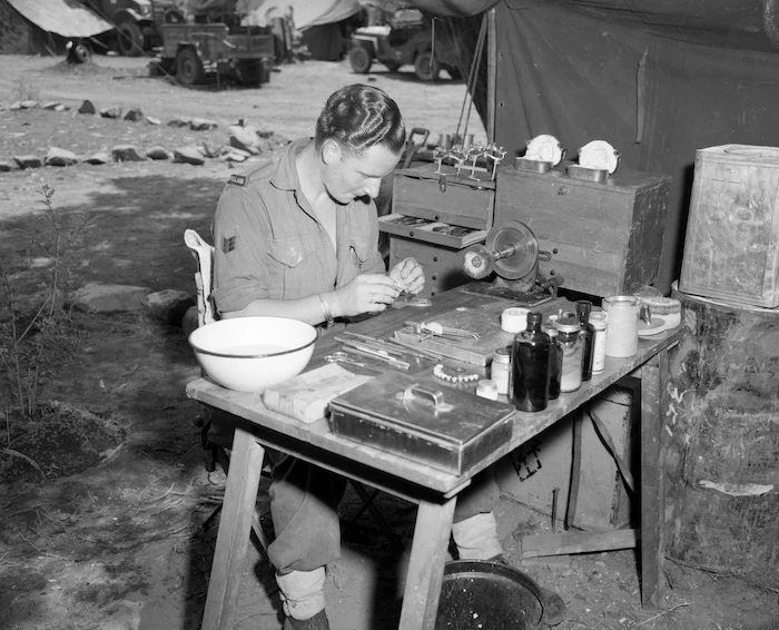 [Sgt M C Cottle repairing dentures in the field, Korea]