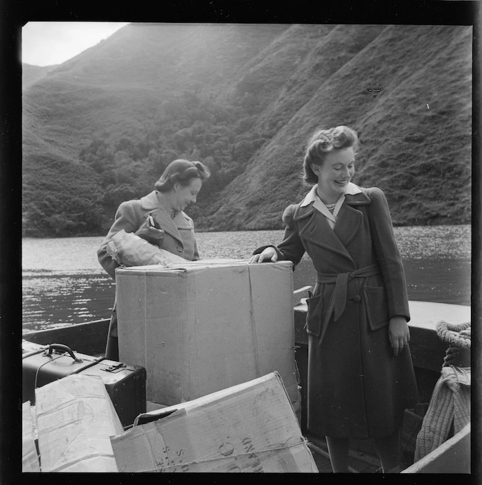 Women, and packages, on a mail launch arriving at Picton