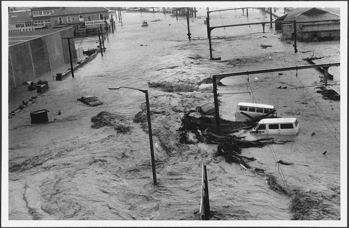 Motor vehicles and debris in a flooded street, Wellington.