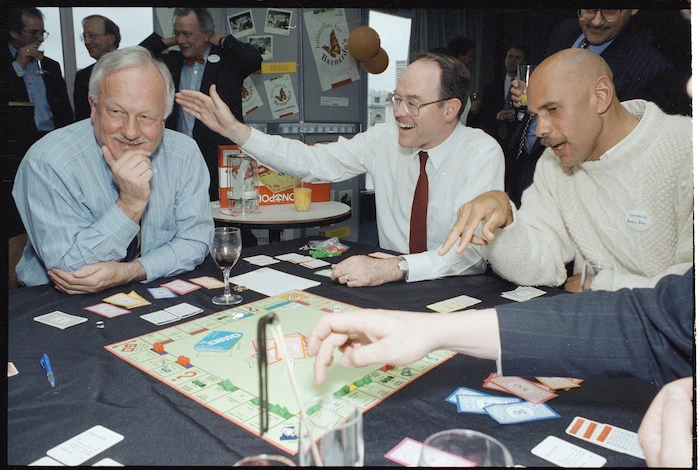 Former Finance Minister Sir Roger Douglas, Reserve Bank governor Don Brash, and Saints basketballer Angelo Hill, playing Monopoly for charity - Photograph taken by Ray Pigney