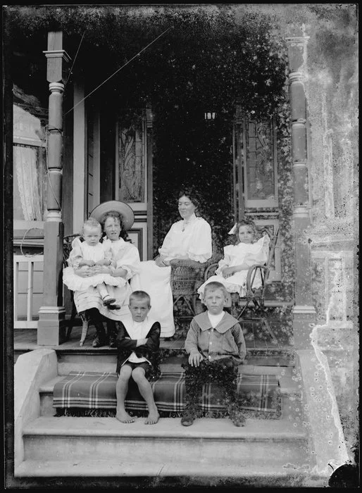 Woman and children of Nicol family on verandah
