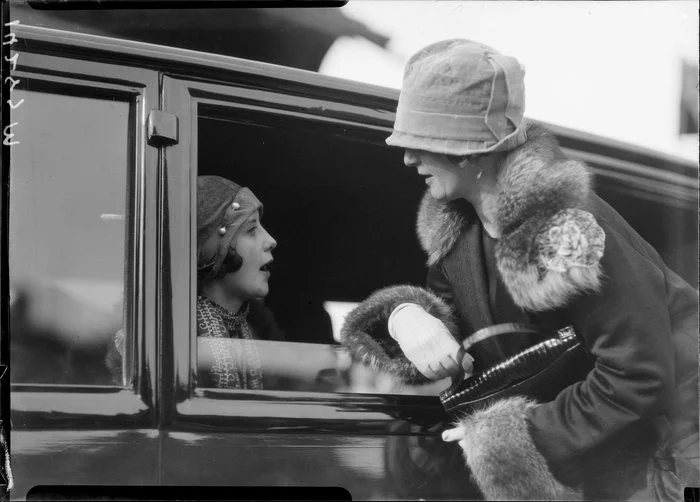 Two unidentified women talking through car window