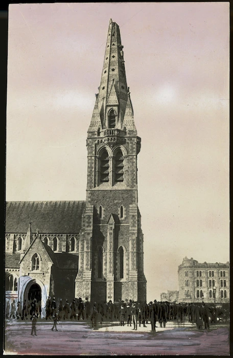 Creator unknown :Photograph of crowd outside Christ Church Cathedral with earthquake damage to spire, Christchurch