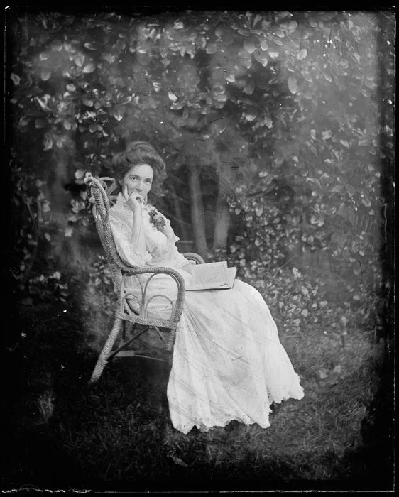 Woman seated in cane chair outdoors