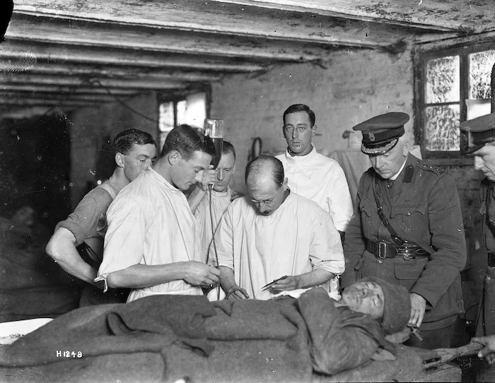 Members of the 2nd NZ Field Ambulance, injecting gum infusion into a patient