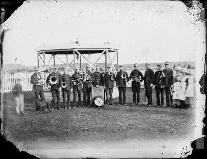 A brass band posing in front of a band rotunda, Wanganui