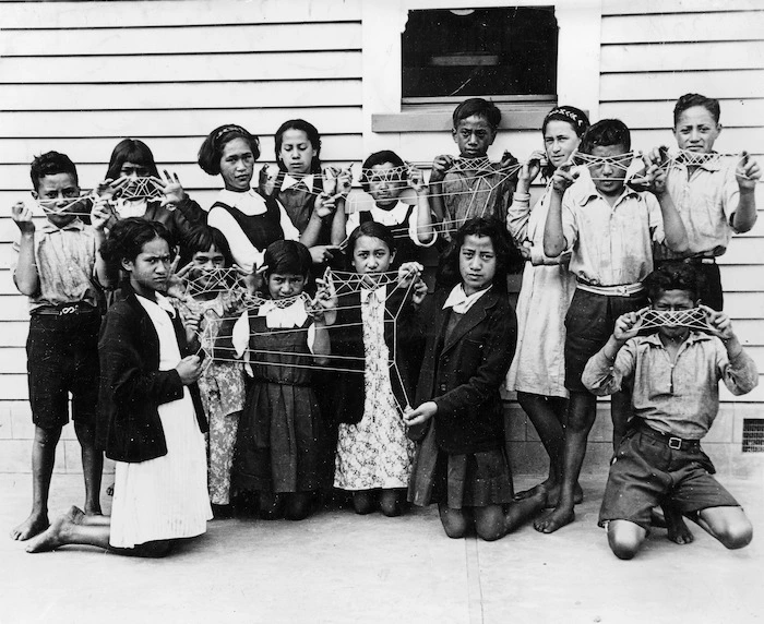 Children holding Maori string patterns