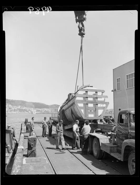 Crane lowering boiler onto truck