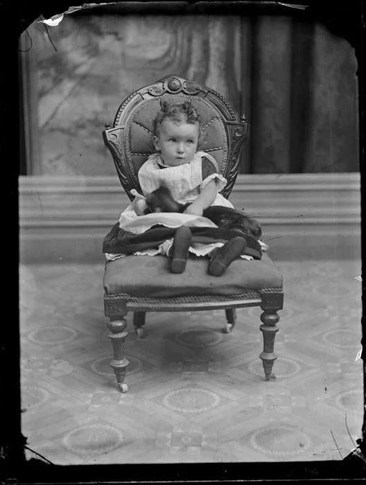 Unidentified infant with cat