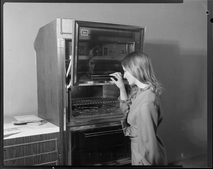 Woman demonstrating Caprice wall oven