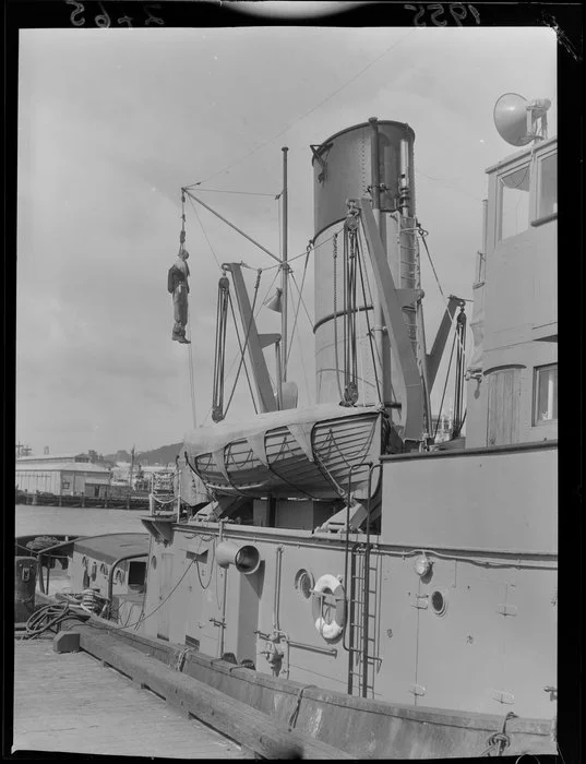 A Guy Fawkes figure hanging from a yard on the tug Tapuhi, Wellington
