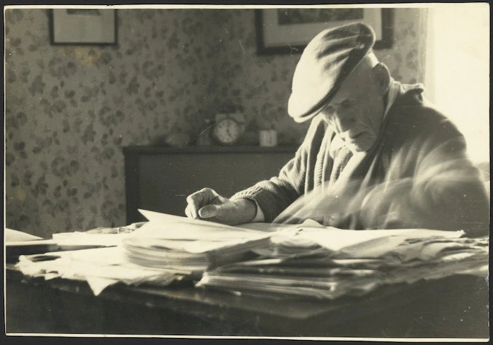 James Cowan at his desk, writing