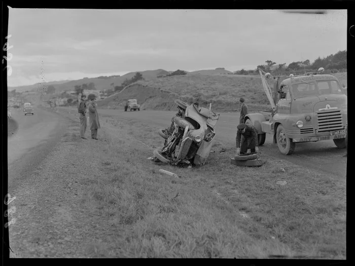 A T W Collins & Son tow truck beside a crashed car on the highway [Wellington region?]
