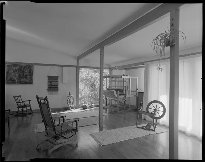 Interior of Calvert house, Stokes Valley, Lower Hutt, showing rocking chairs, loom and spinning wheels