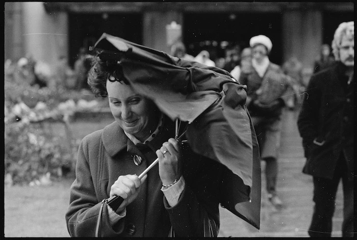 Woman holding a crumpled umbrella, Wellington