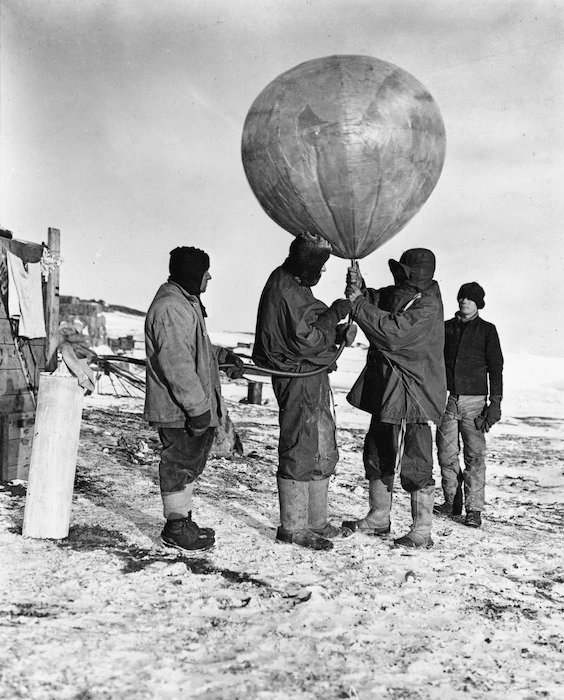 Dr George C. Simpson inflating meteorological balloon, Antarctica