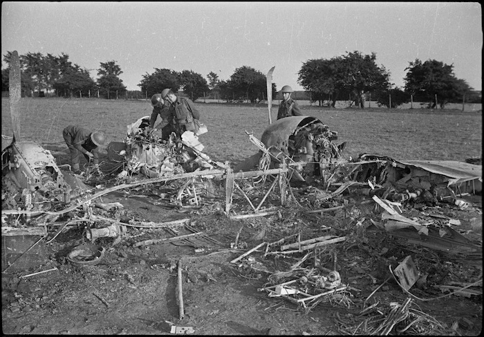 New Zealand World War II soldiers in England inspecting a Messerschmitt fighter plane shot down by an Allied fighter