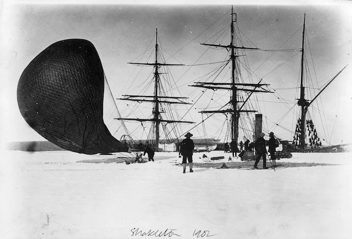 Group alongside a ship and a hydrogen balloon, 1901-4 British Antarctic expedition